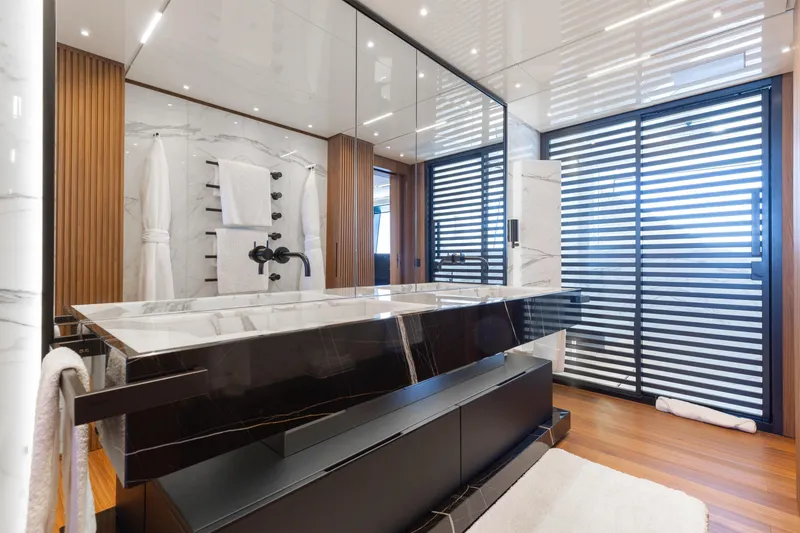 Slide: The Image of Luxurious 2020 Sanlorenzo 44 Alloy yacht deck with elegant dining setup and ocean view. - 59