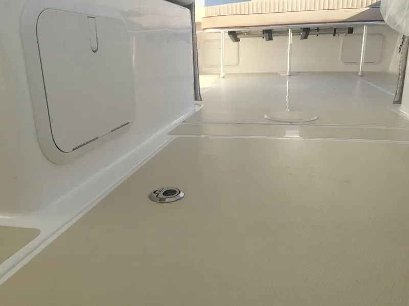 Slide: The Image of 2024 NorthCoast 235 HT boat interior with spacious deck and storage compartments. - 12