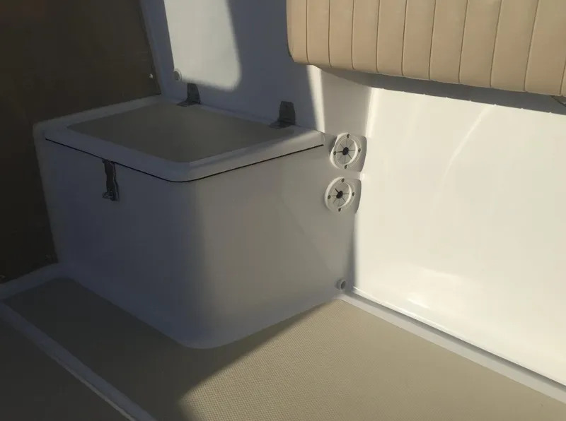 Slide: The Image of 2024 NorthCoast 235 HT boat interior with seating and storage compartment. - 13