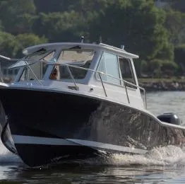 Slide: The Image of 2024 NorthCoast 235 HT boat cruising on water, showcasing sleek design and performance. - 2