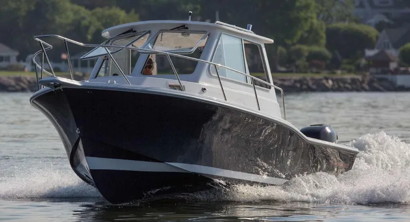 Slide: The Image of 2024 NorthCoast 235 HT boat cruising on water, showcasing sleek design and performance. - 3