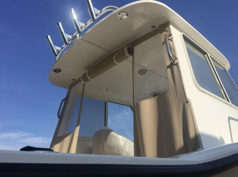 Slide: The Image of 2024 NorthCoast 235 HT boat, featuring a sleek cabin design under a clear blue sky. - 6
