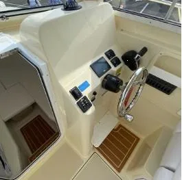 Slide: The Image of 2024 NorthCoast 235 HT boat helm with steering wheel and control panel. - 9