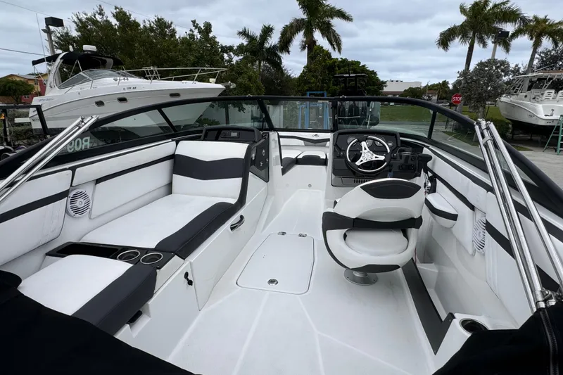 Slide: The Image of 2020 Monterey M-225 boat interior with sleek seating and modern steering console. - 12