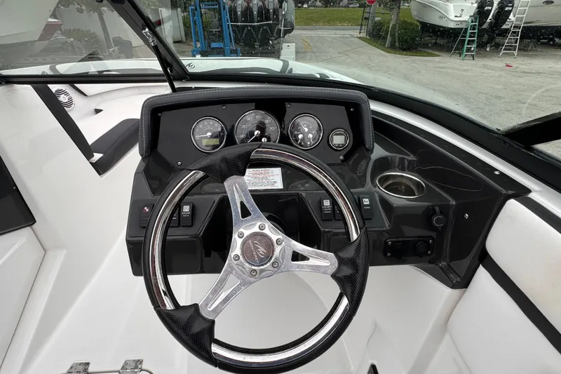 Slide: The Image of Steering wheel and dashboard of a 2020 Monterey M-225 boat. - 14