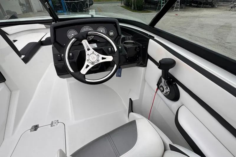 Slide: The Image of 2020 Monterey M-225 boat cockpit with steering wheel and control panel. - 15