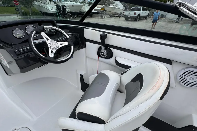 Slide: The Image of Interior of a 2020 Monterey M-225 boat with steering wheel and control panel. - 16