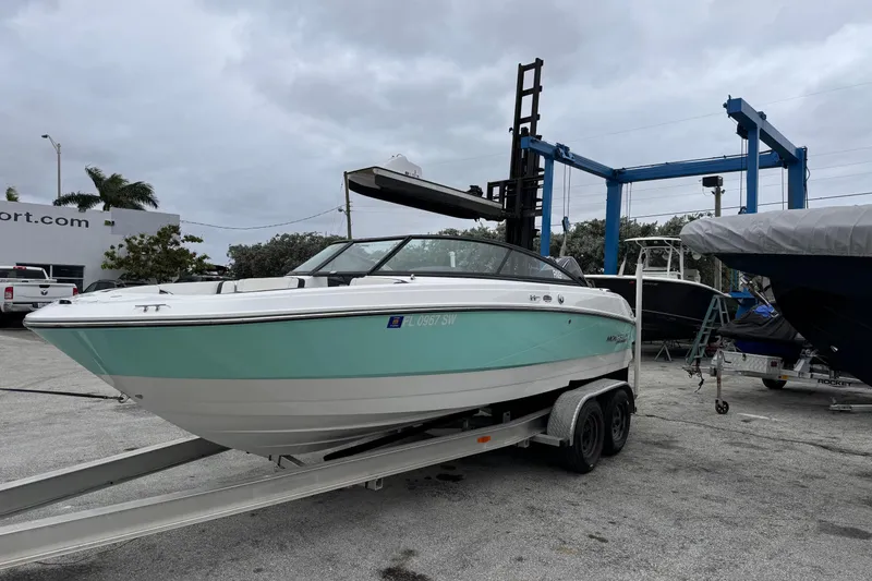 Slide: The Image of 2020 Monterey M-225 boat on trailer at marina, overcast sky. - 6
