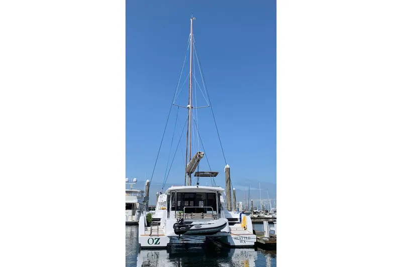 Slide: The Image of Sailing catamaran Bali 4.1, 2019 model, docked in a marina under clear blue skies. - 1