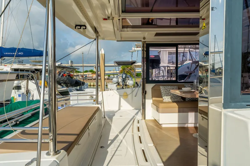 Slide: The Image of Interior of 2019 Bali 4.1 catamaran with modern seating and dining area. - 14
