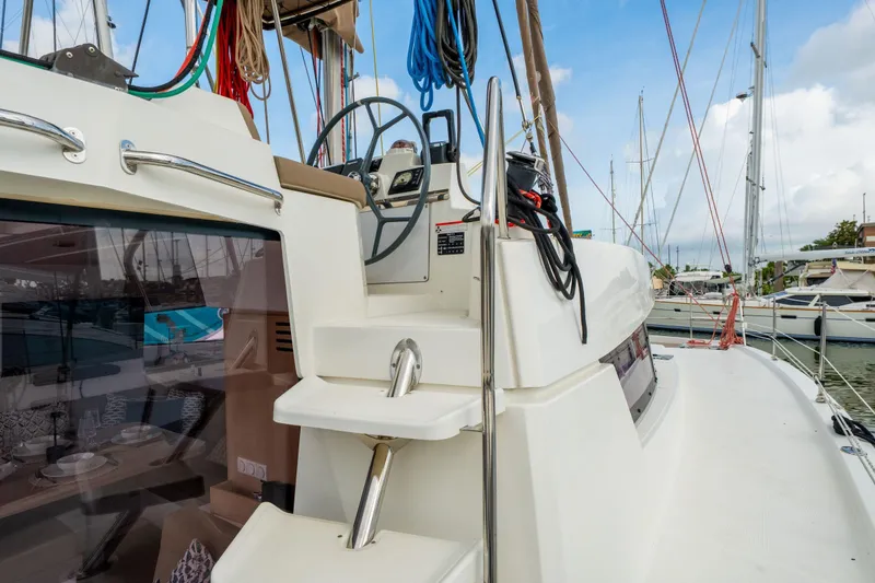 Slide: The Image of Luxurious interior of a 2019 Bali 4.1 yacht with elegant dining setup and marina view. - 17