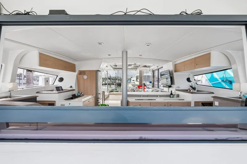 Slide: The Image of Luxurious interior of a 2019 Bali 4.1 yacht with elegant dining setup and marina view. - 19