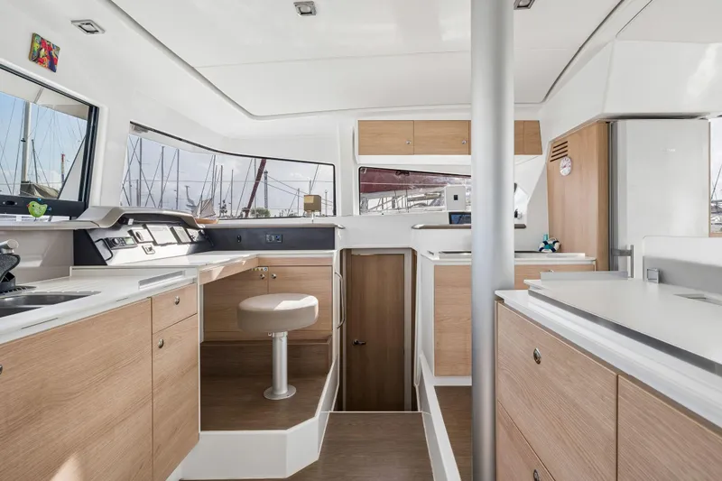 Slide: The Image of Modern interior of a 2019 Bali 4.1 yacht, featuring sleek wood finishes and compact design. - 27
