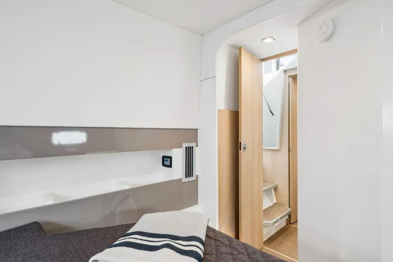 Slide: The Image of Interior of 2019 Bali 4.1 yacht with modern wood cabinetry and open floor panel. - 43