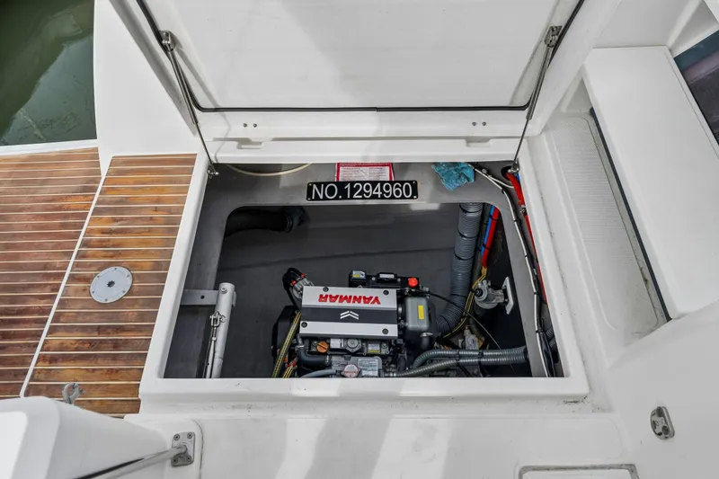 Slide: The Image of Modern 2019 Bali 4.1 catamaran with spacious deck seating in a marina setting. - 52