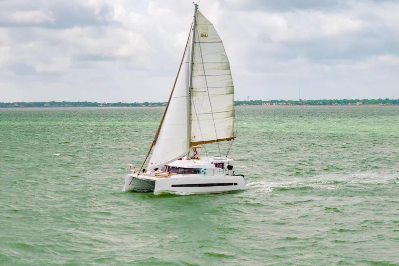 Slide: The Image of 2019 Bali 4.1 yacht interior with seating and dining area, docked at marina. - 7