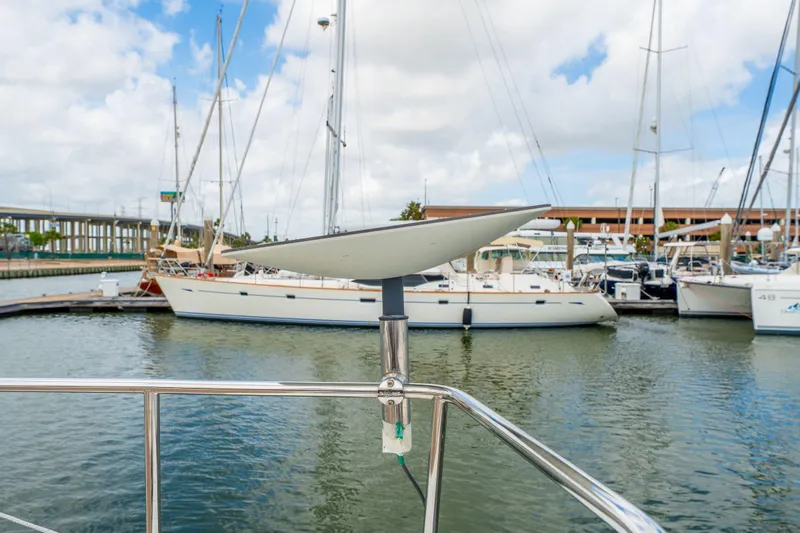 Slide: The Image of Sailboat Bali 4.1 cruising on calm green waters under cloudy skies, 2019 model. - 77