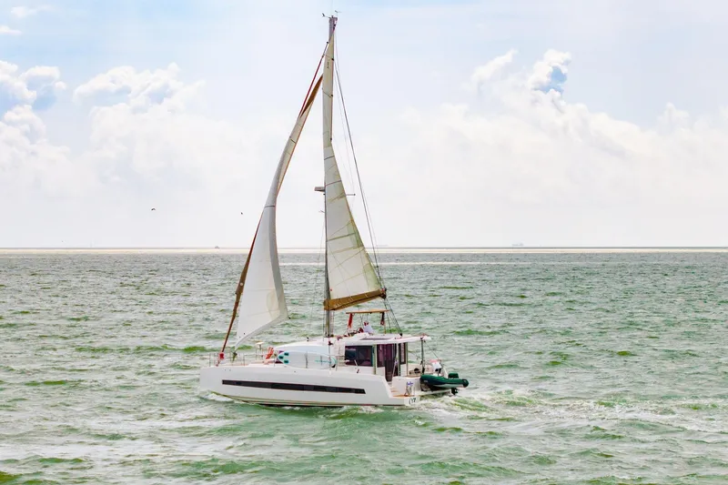 Slide: The Image of 2019 Bali 4.1 catamaran interior with seating area and open deck view. - 8