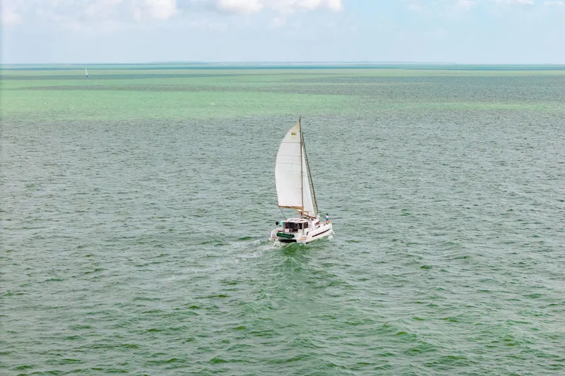 Slide: The Image of Sailing catamaran Bali 4.1, 2019 model, cruising on open sea under clear skies. - 80
