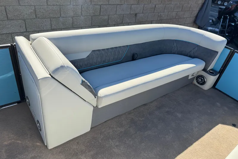 Slide: The Image of 2021 Crest Classic Platinum 240 SLC boat seating with gray upholstery and speaker. - 11