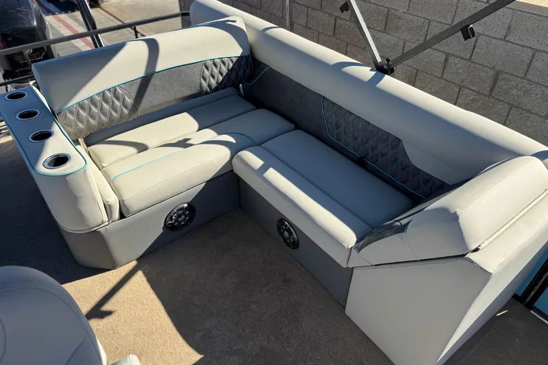 Slide: The Image of Luxurious seating on 2021 Crest Classic Platinum 240 SLC pontoon boat, featuring cup holders and speakers. - 15