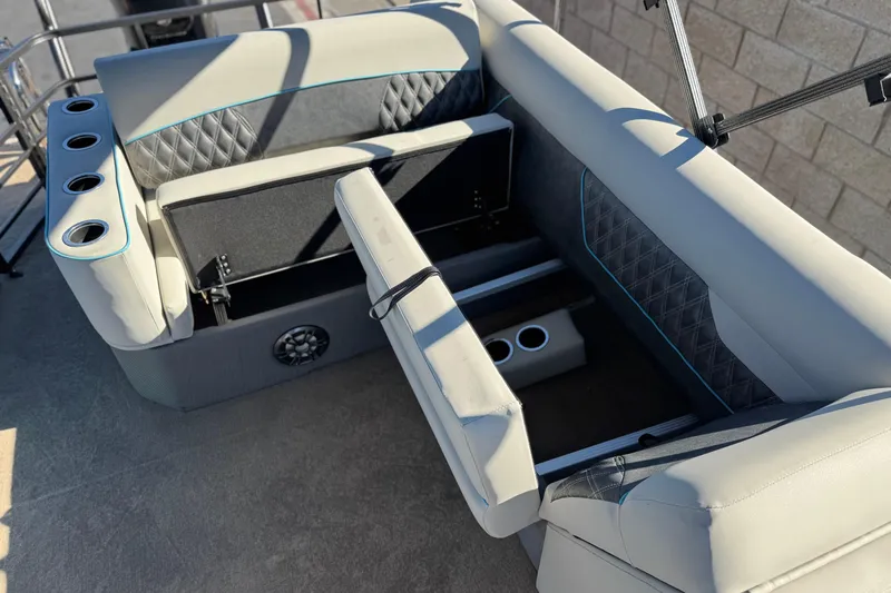 Slide: The Image of 2021 Crest Classic Platinum 240 SLC boat interior with storage and cup holders. - 16