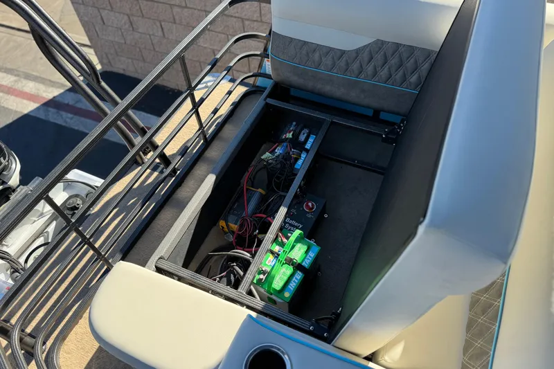 Slide: The Image of Open battery compartment of 2021 Crest Classic Platinum 240 SLC boat, showcasing wiring and components. - 19