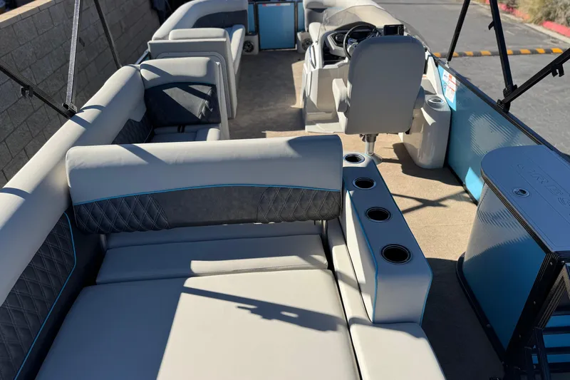 Slide: The Image of 2021 Crest Classic Platinum 240 SLC pontoon boat interior with luxurious seating and cup holders. - 21