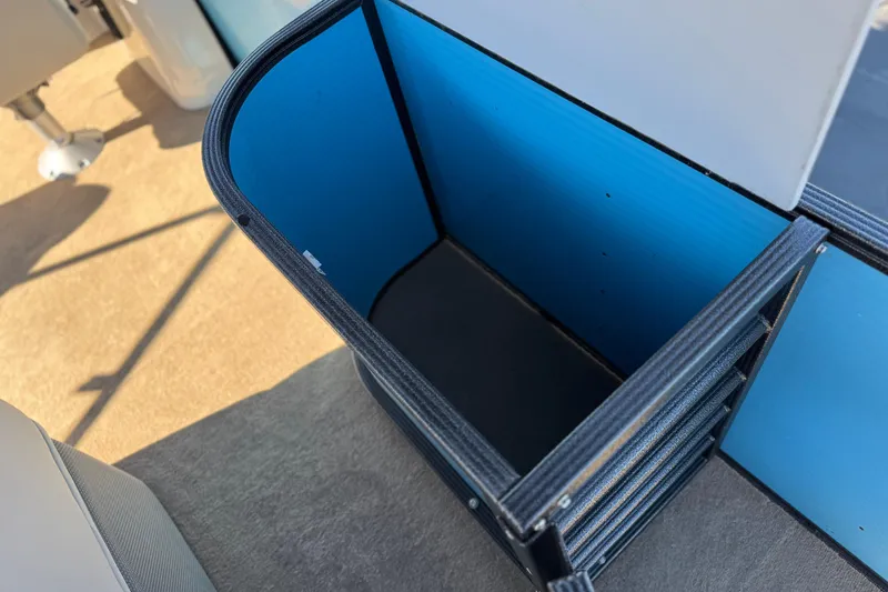 Slide: The Image of Storage compartment on a 2021 Crest Classic Platinum 240 SLC boat, featuring blue interior. - 23