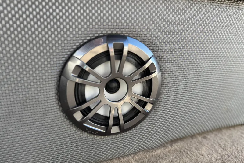 Slide: The Image of Speaker on 2021 Crest Classic Platinum 240 SLC boat, embedded in gray upholstery. - 24