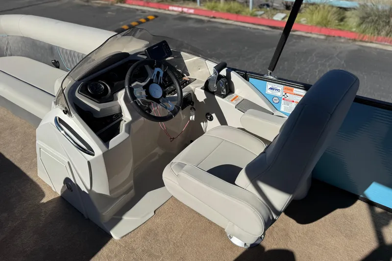 Slide: The Image of 2021 Crest Classic Platinum 240 SLC boat interior with steering wheel and captain's chair. - 25