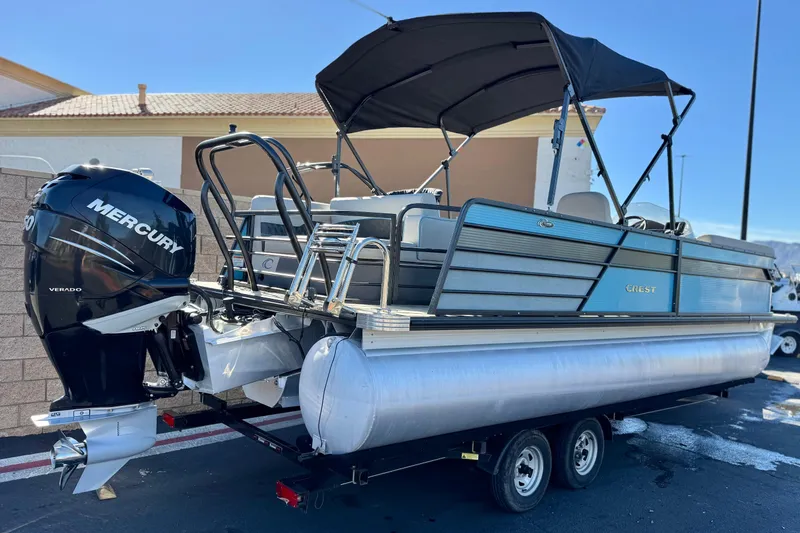 Slide: The Image of 2021 Crest Classic Platinum 240 SLC pontoon boat with Mercury Verado engine on trailer. - 6
