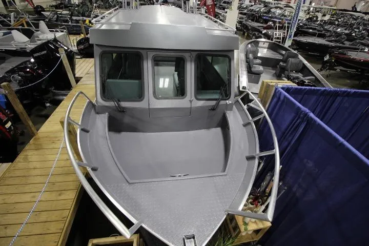 Slide: The Image of 2026 Alumaweld Horizon 24 boat displayed at an indoor exhibition. - 1
