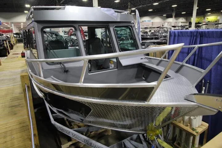 Slide: The Image of 2026 Alumaweld Horizon 24 boat displayed indoors on a trailer. - 14