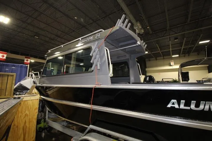 Slide: The Image of 2026 Alumaweld Horizon 24 boat displayed indoors, showcasing sleek design and modern features. - 15