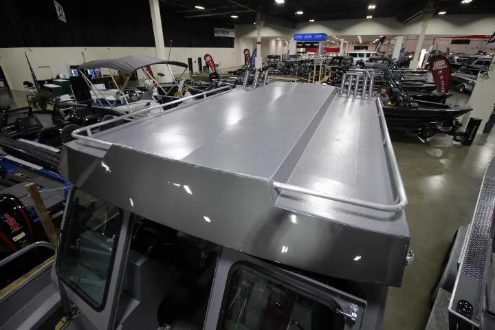 Slide: The Image of 2026 Alumaweld Horizon 24 boat showcased at an indoor exhibition, highlighting its sleek design. - 4