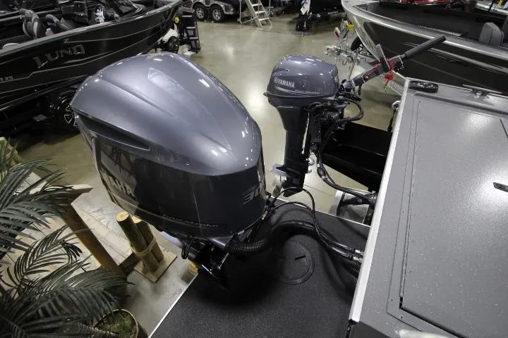 Slide: The Image of 2026 Alumaweld Horizon 24 boat with Yamaha outboard motors displayed indoors. - 8