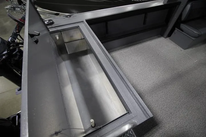 Slide: The Image of 2026 Alumaweld Horizon 24 boat interior with storage compartment and textured flooring. - 9