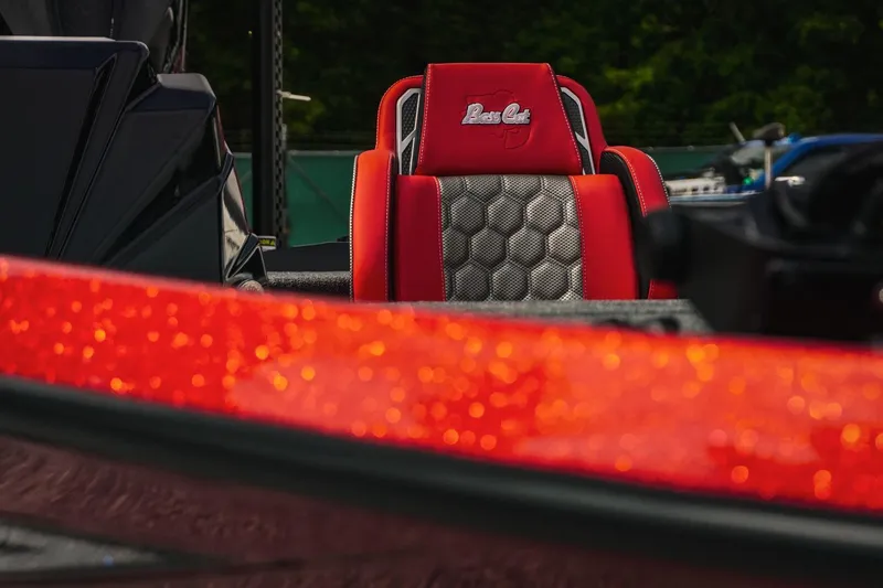 Slide: The Image of 2026 Bass Cat Cougar FTD boat seat with red and silver design, close-up view. - 19