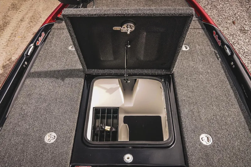 Slide: The Image of 2026 Bass Cat Cougar FTD boat storage compartment with open lid, showcasing interior design. - 25