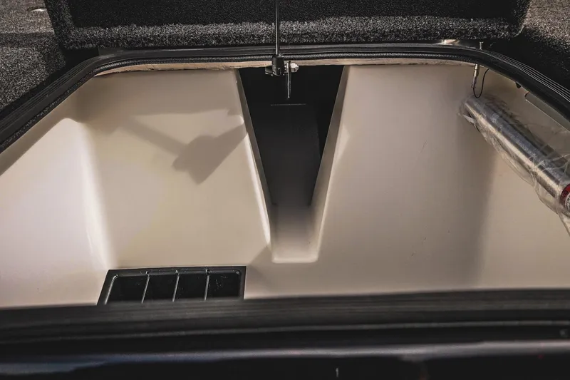 Slide: The Image of 2026 Bass Cat Cougar FTD storage compartment, open lid, spacious interior, organized layout. - 27