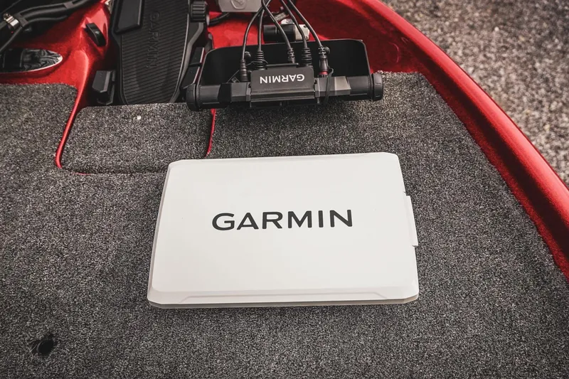 Slide: The Image of 2026 Bass Cat Cougar FTD boat with Garmin device on carpeted deck. - 31