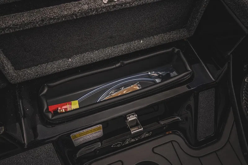 Slide: The Image of 2026 Bass Cat Cougar FTD storage compartment with organized fishing gear. - 33