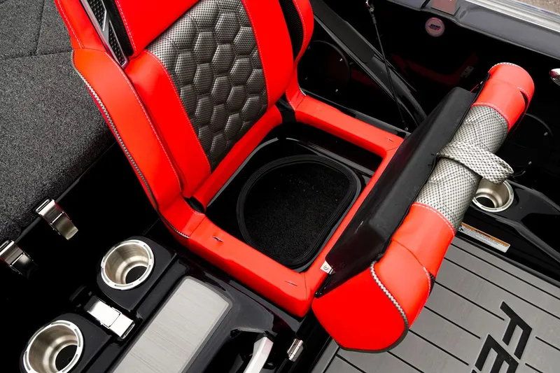 Slide: The Image of 2026 Bass Cat Cougar FTD interior with red and black seating, cup holders, and storage. - 37