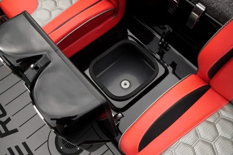 Slide: The Image of 2026 Bass Cat Cougar FTD interior with red seats and storage compartment. - 39