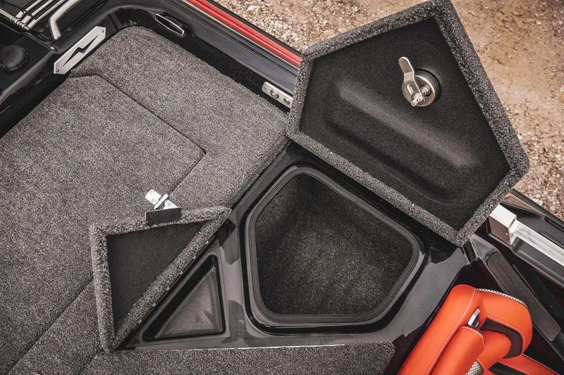 Slide: The Image of 2026 Bass Cat Cougar FTD storage compartment with open hatch and carpeted interior. - 45