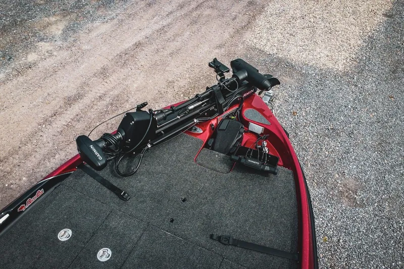 Slide: The Image of 2026 Bass Cat Cougar FTD boat deck with Garmin equipment, on gravel surface. - 55