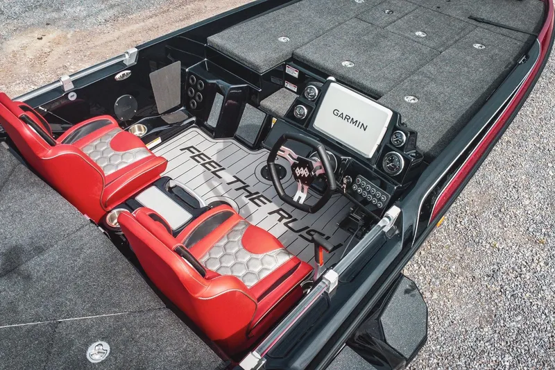 Slide: The Image of 2026 Bass Cat Cougar FTD boat interior with red seats and Garmin navigation system. - 6