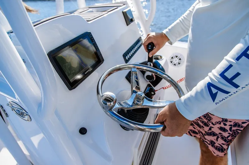 Slide: The Image of 2026 Tidewater 198 CC Adventure boat console with steering wheel and navigation display. - 12