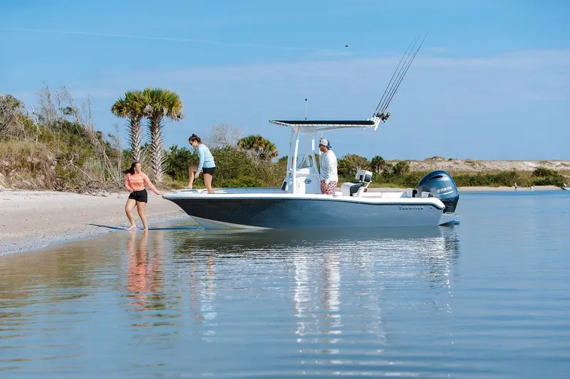 Slide: The Image of 2026 Tidewater 198 CC Adventure boat near sandy beach with people enjoying the water. - 6